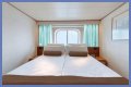 An old Holland America cruise ship is turning residential, letting travelers live at sea for $8,000 a month while it circumnavigates the globe
